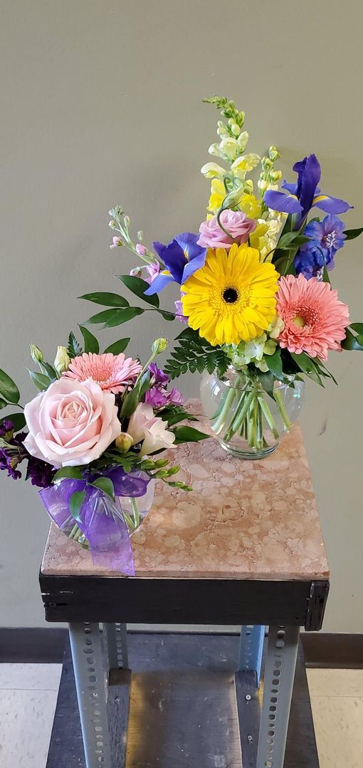 A vase filled with flowers is sitting on a table.