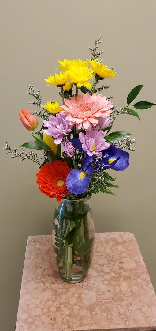 A vase filled with flowers is sitting on a table.