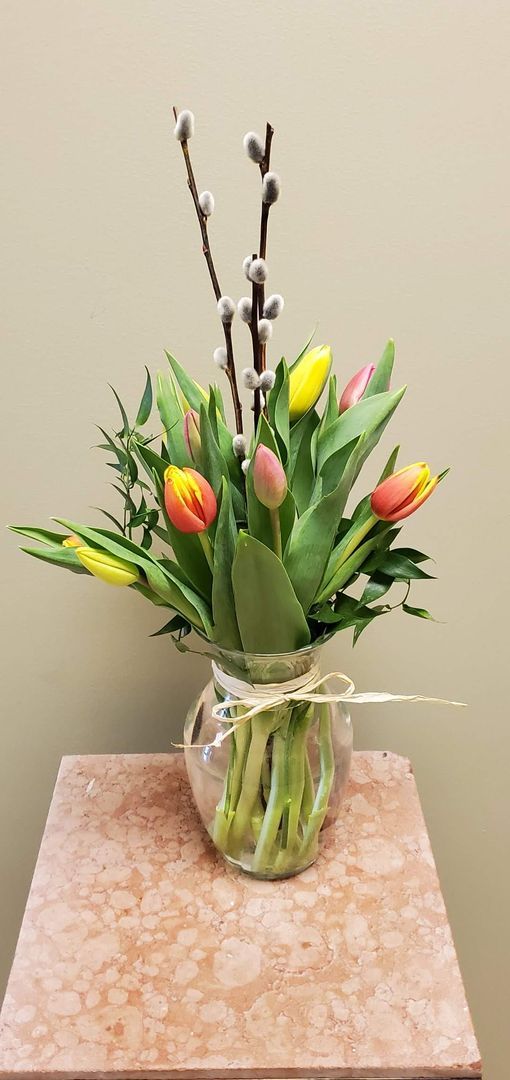 A vase filled with flowers is sitting on a table.