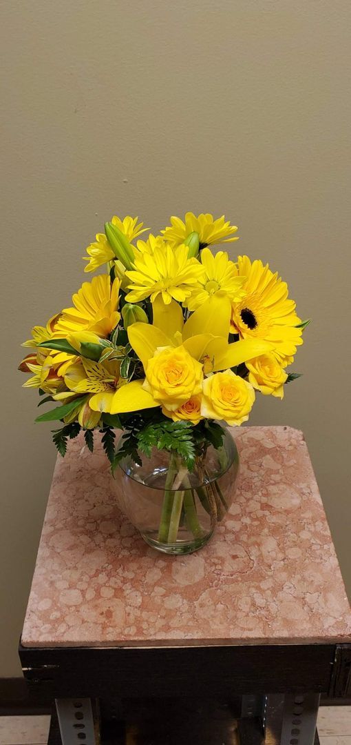 A vase filled with flowers is sitting on a table.