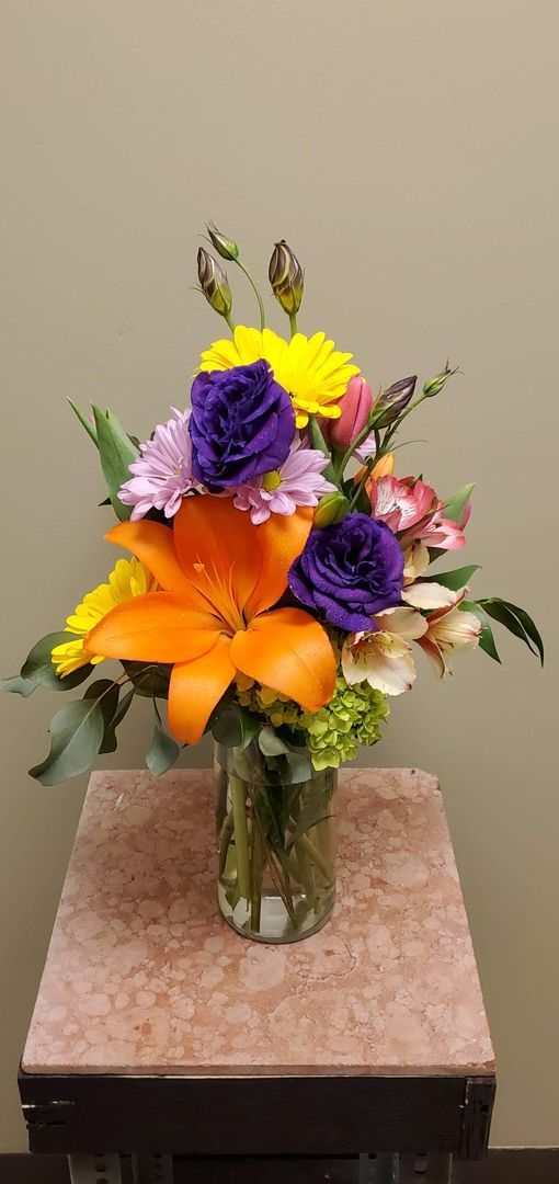 A vase filled with flowers is sitting on a table.