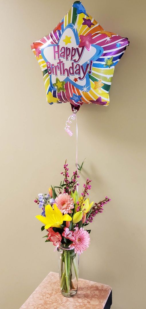 A vase filled with flowers is sitting on a table.
