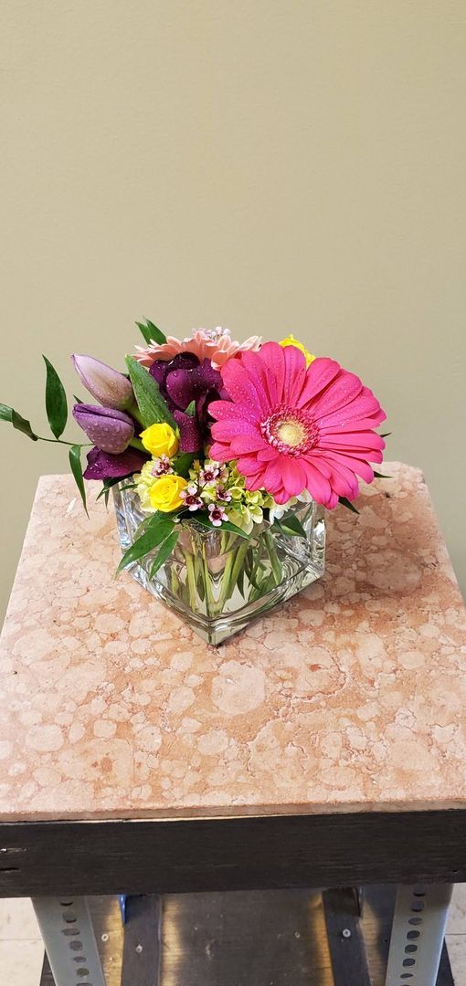 A vase filled with flowers is sitting on a table.
