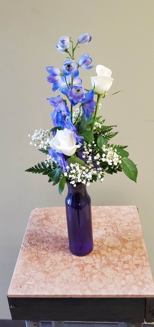 A vase filled with flowers is sitting on a table.