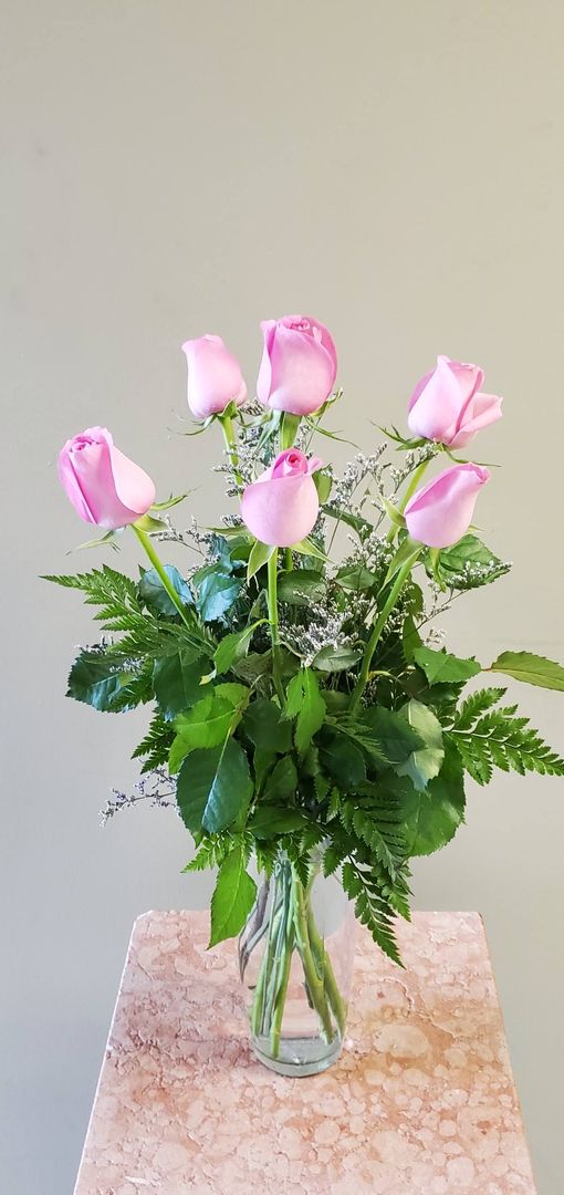 A vase filled with flowers is sitting on a table.