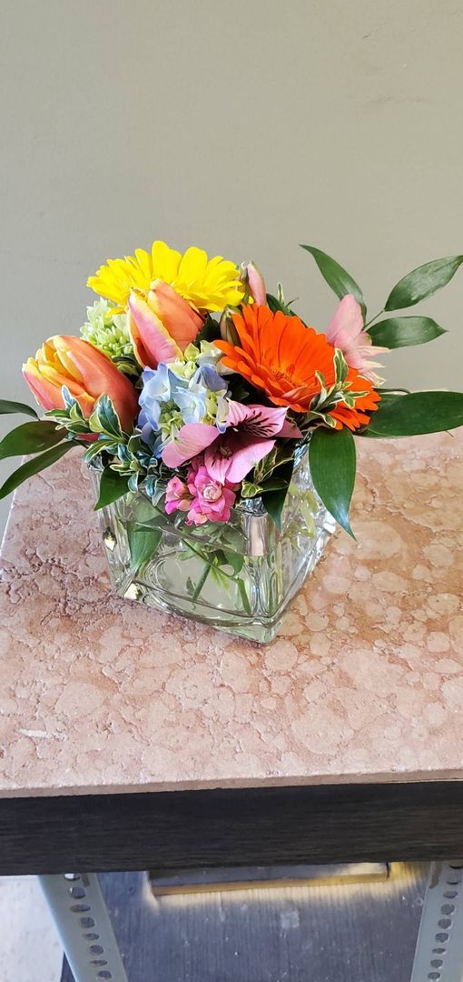 A vase filled with flowers is sitting on a table.