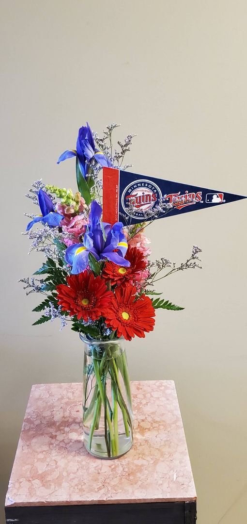 A vase filled with flowers is sitting on a table.