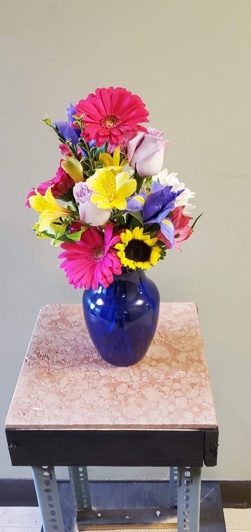 A vase filled with flowers is sitting on a table.