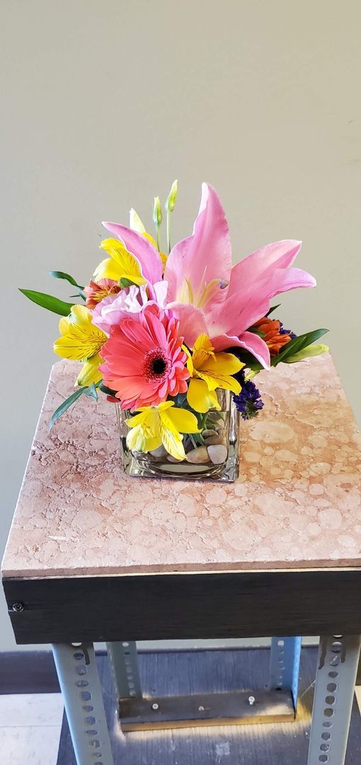 A vase filled with flowers is sitting on a table.