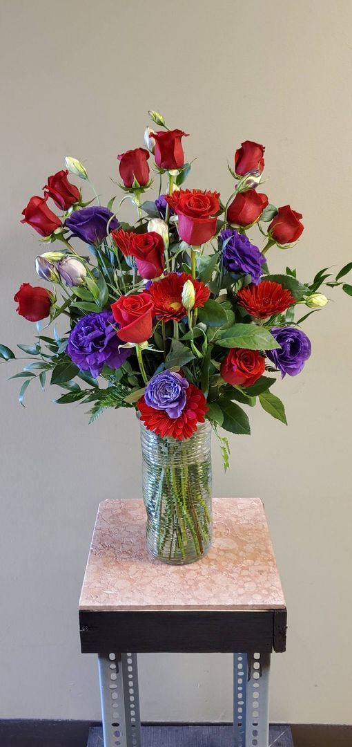 A vase filled with flowers is sitting on a table.