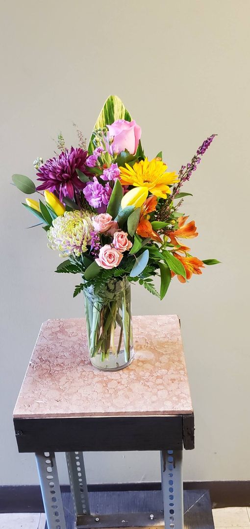 A vase filled with flowers is sitting on a table.