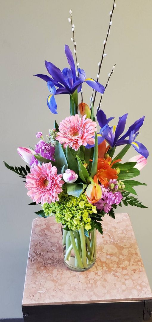 A vase filled with flowers is sitting on a table.