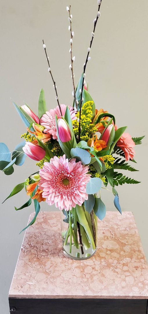 A vase filled with flowers is sitting on a table.