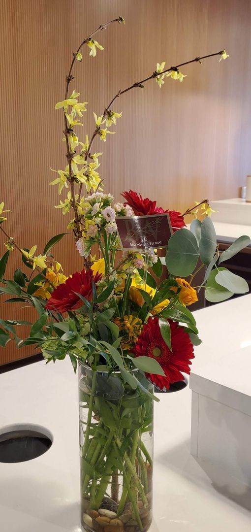 A vase filled with flowers is sitting on a table.