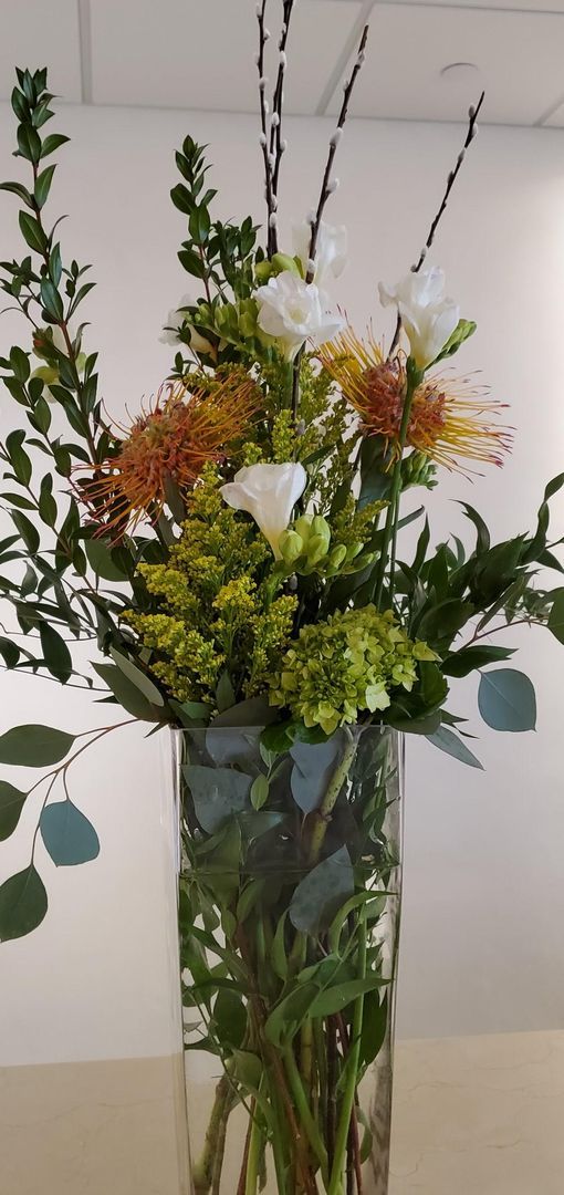 A vase filled with flowers is sitting on a table.