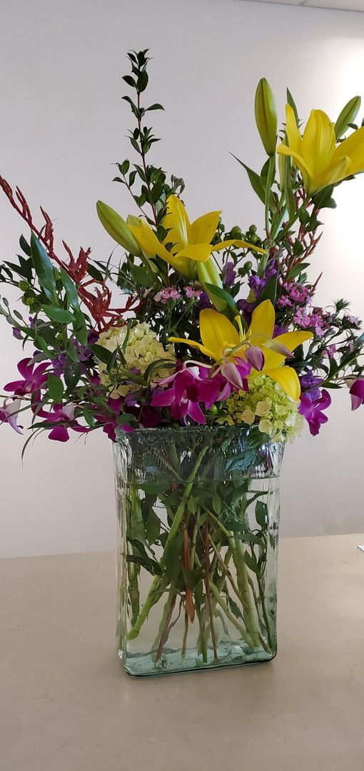 A vase filled with flowers is sitting on a table.