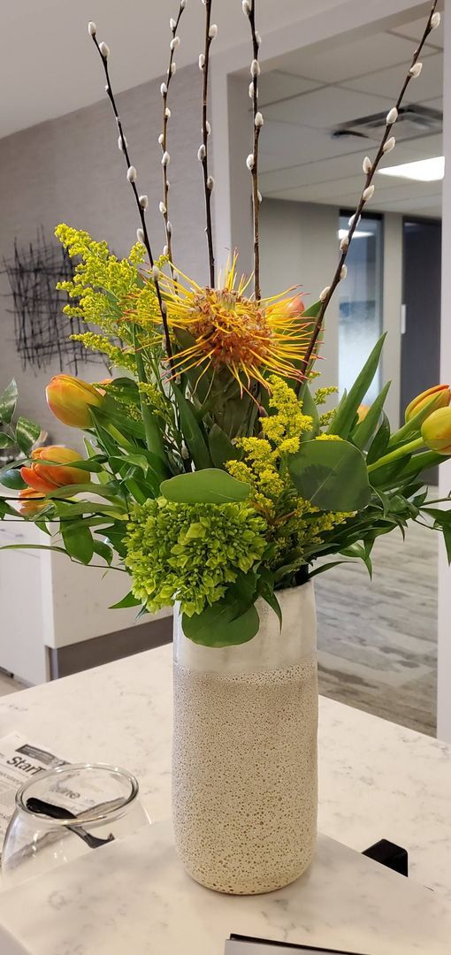 A vase filled with flowers is sitting on a table.