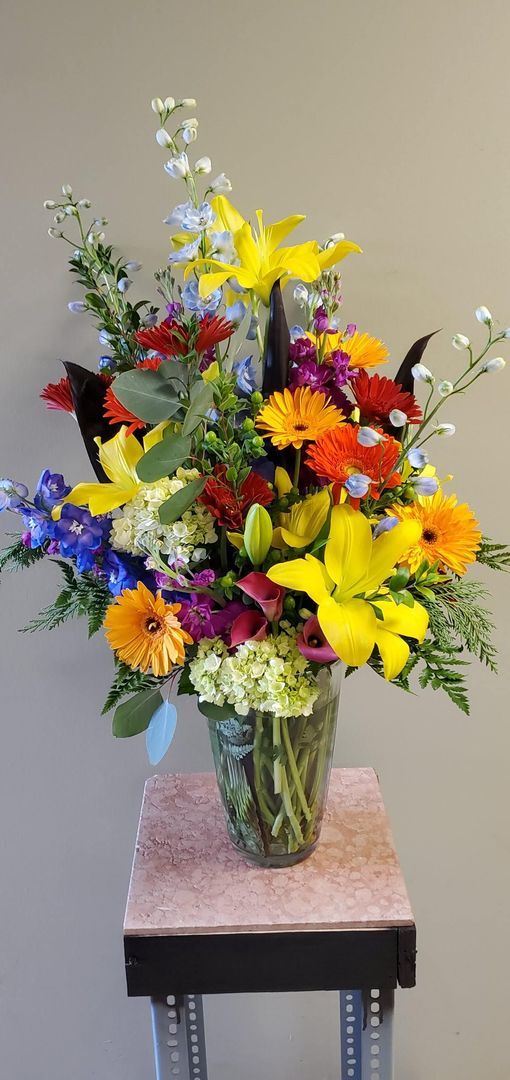 A vase filled with colorful flowers is sitting on a table.