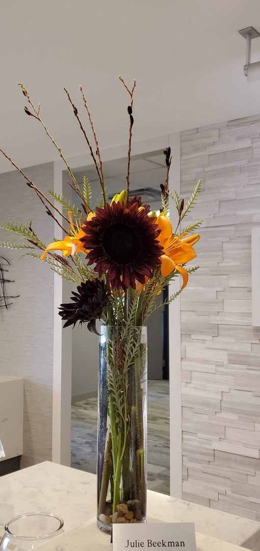 A vase filled with flowers is sitting on a table.