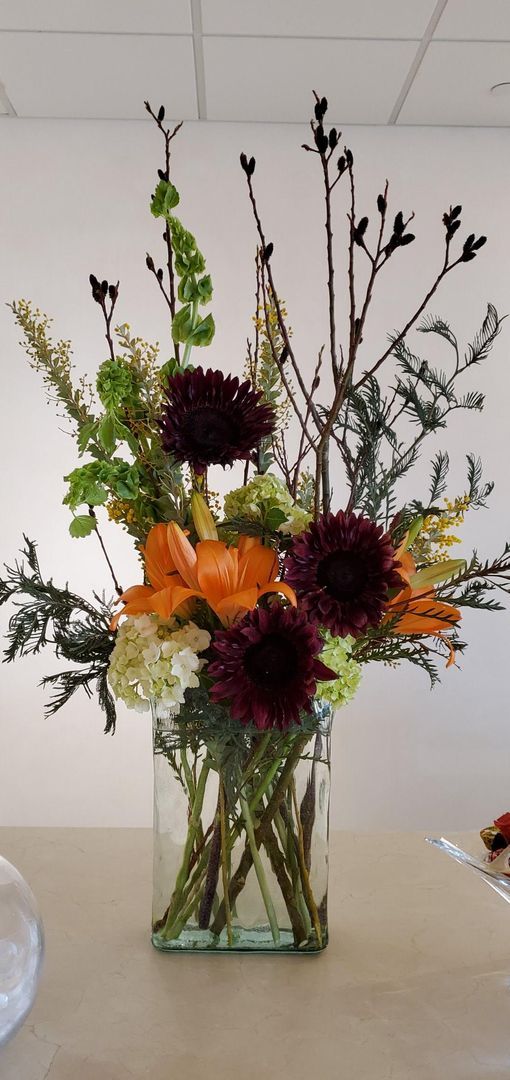 A vase filled with flowers is sitting on a table.
