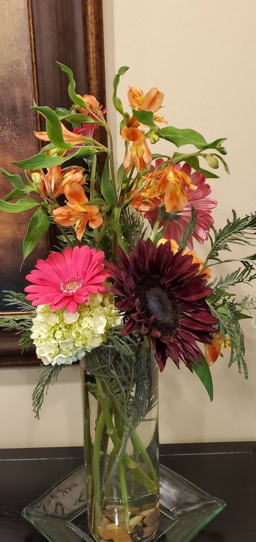A vase filled with flowers is sitting on a table.