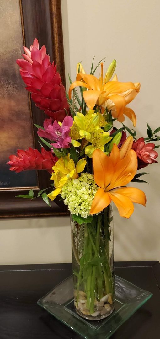 A vase filled with flowers is sitting on a table.