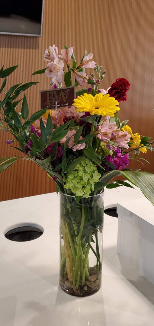 A vase filled with flowers is sitting on a table.