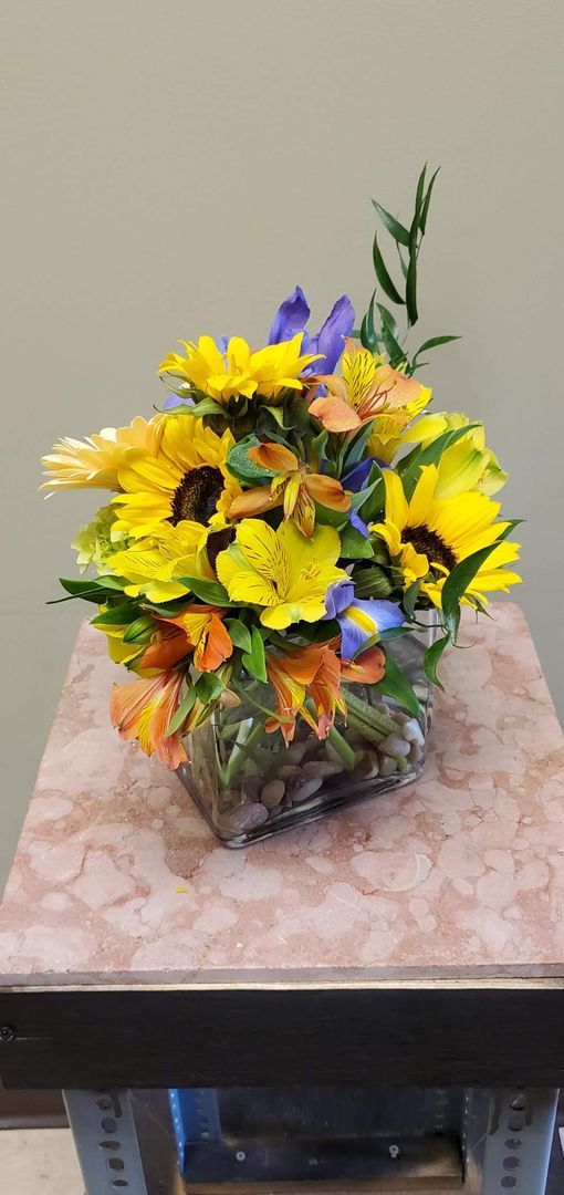 A vase filled with yellow flowers is sitting on a table.