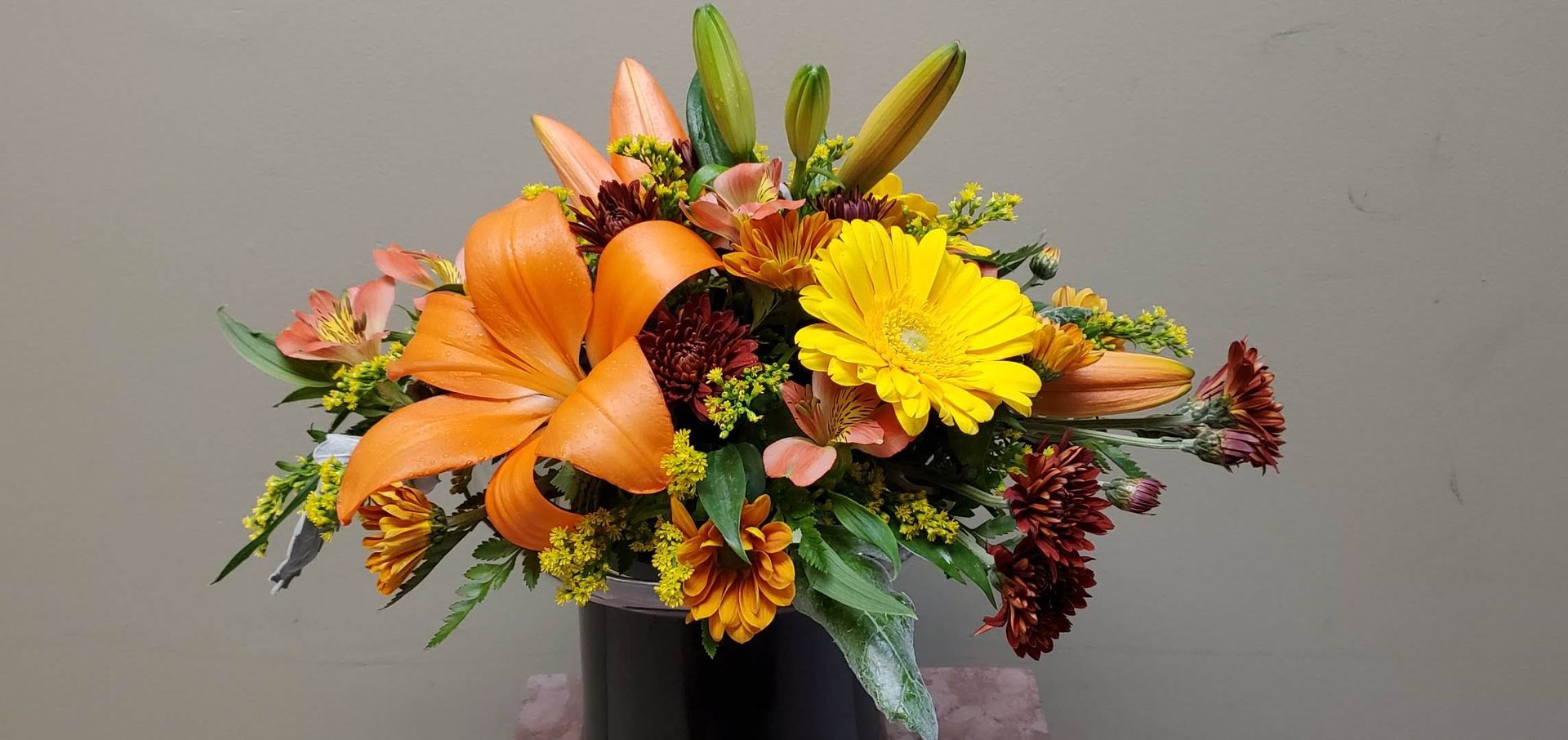 A vase filled with flowers is sitting on a table.