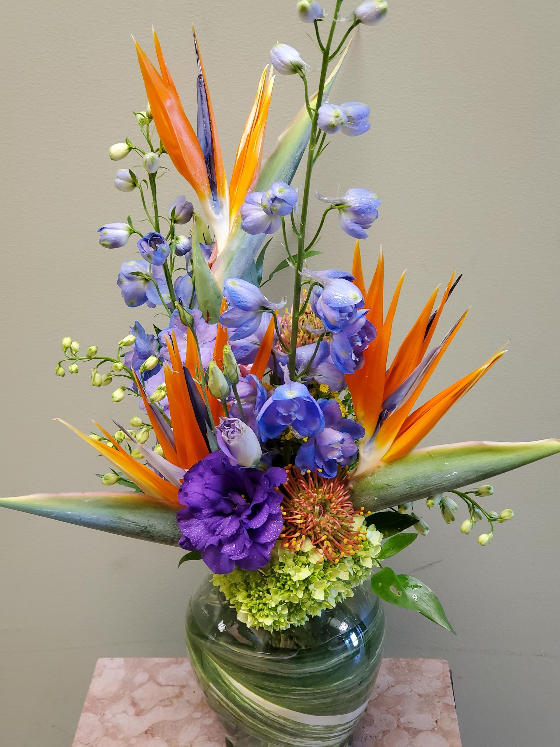 A vase filled with colorful flowers is sitting on a table.