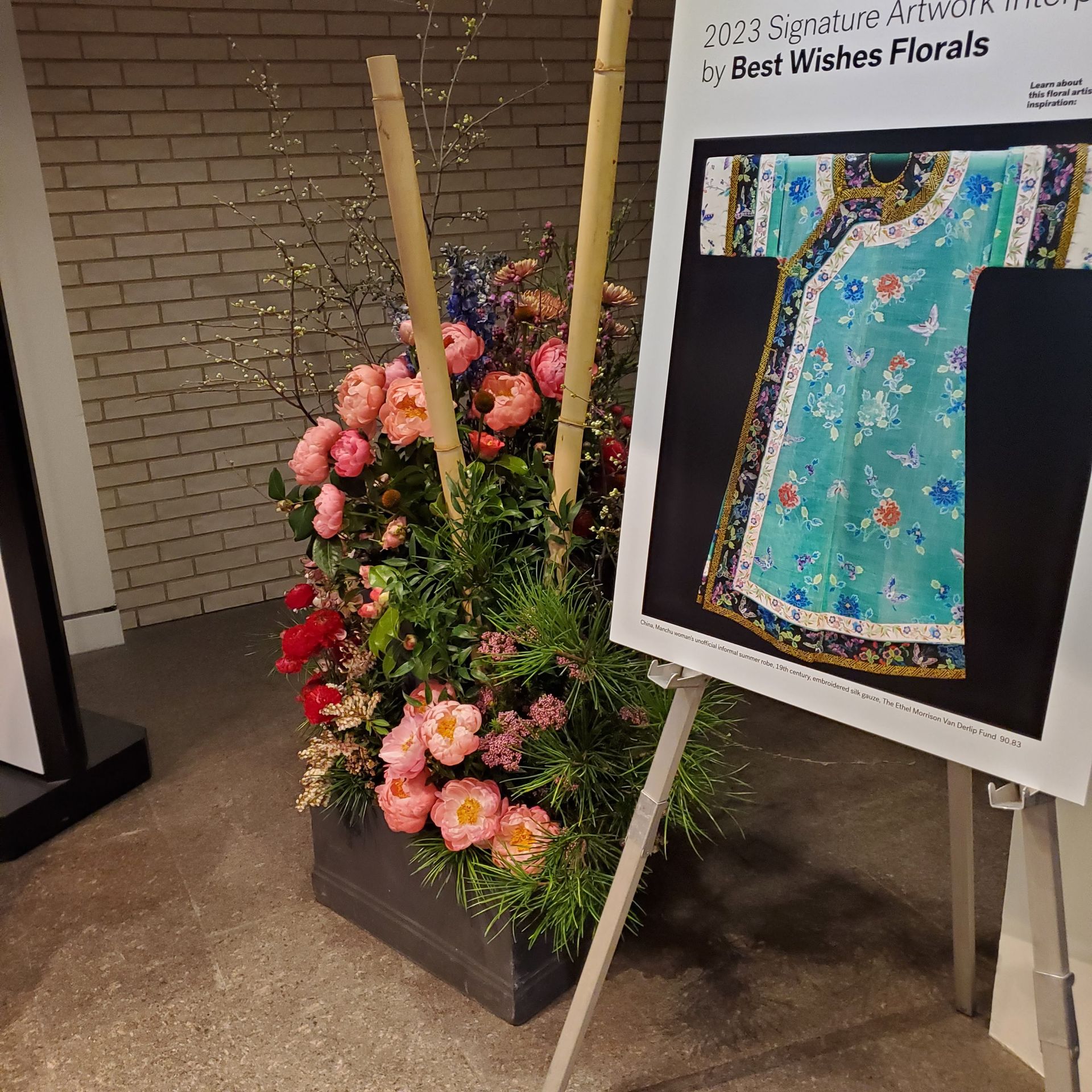 A sign that says best wishes florals on it.