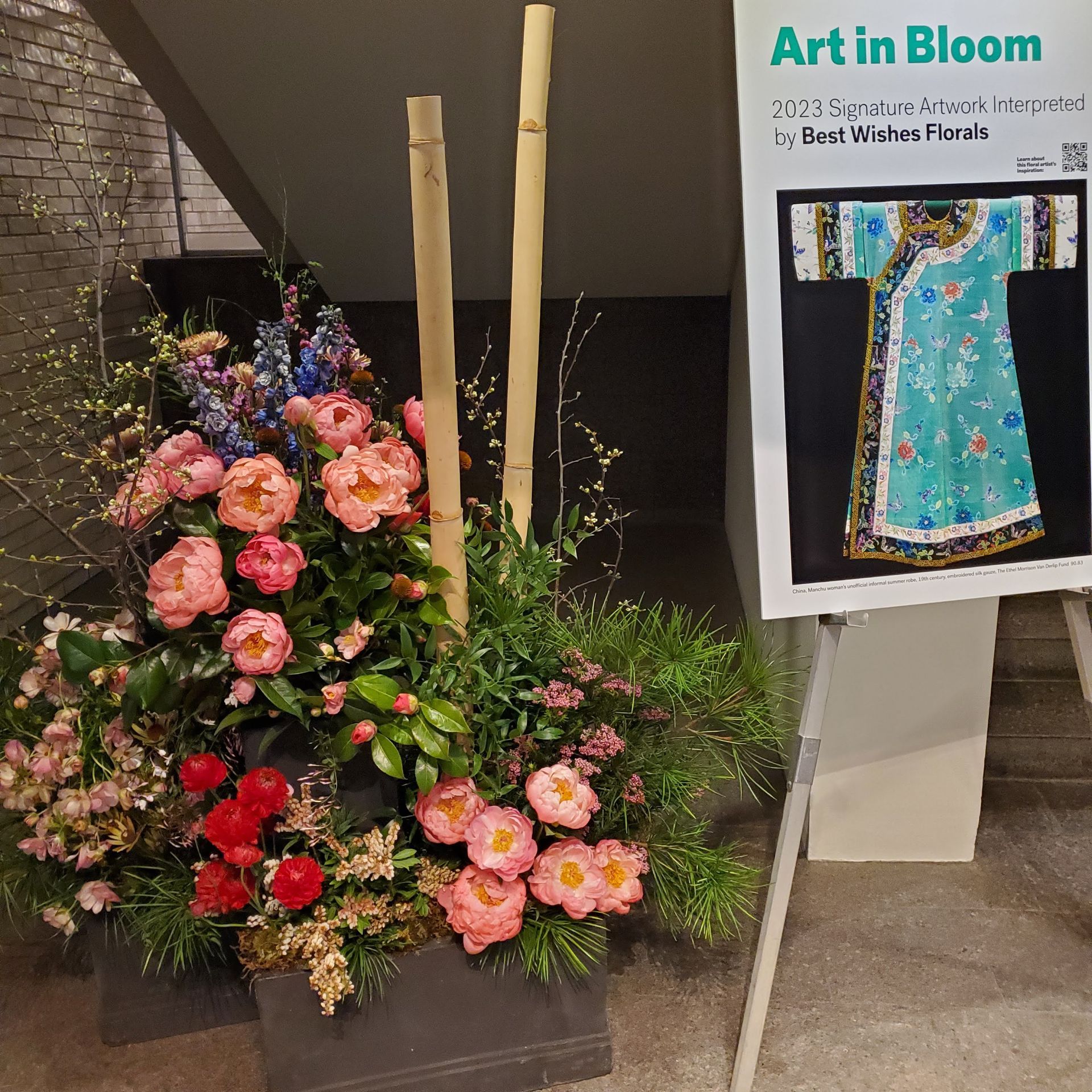 A display of flowers next to a sign that says art in bloom.