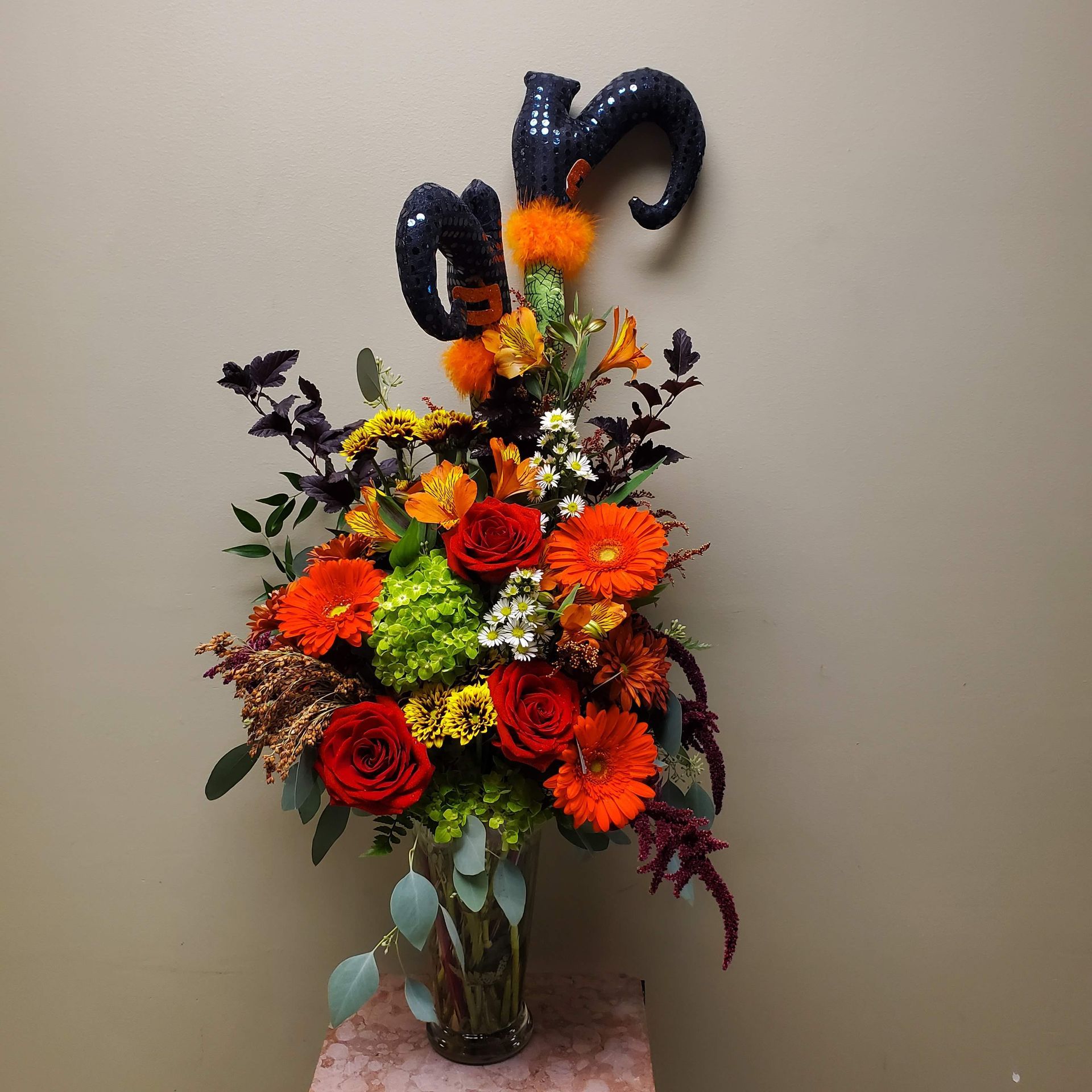 A vase filled with colorful flowers sits on a table.