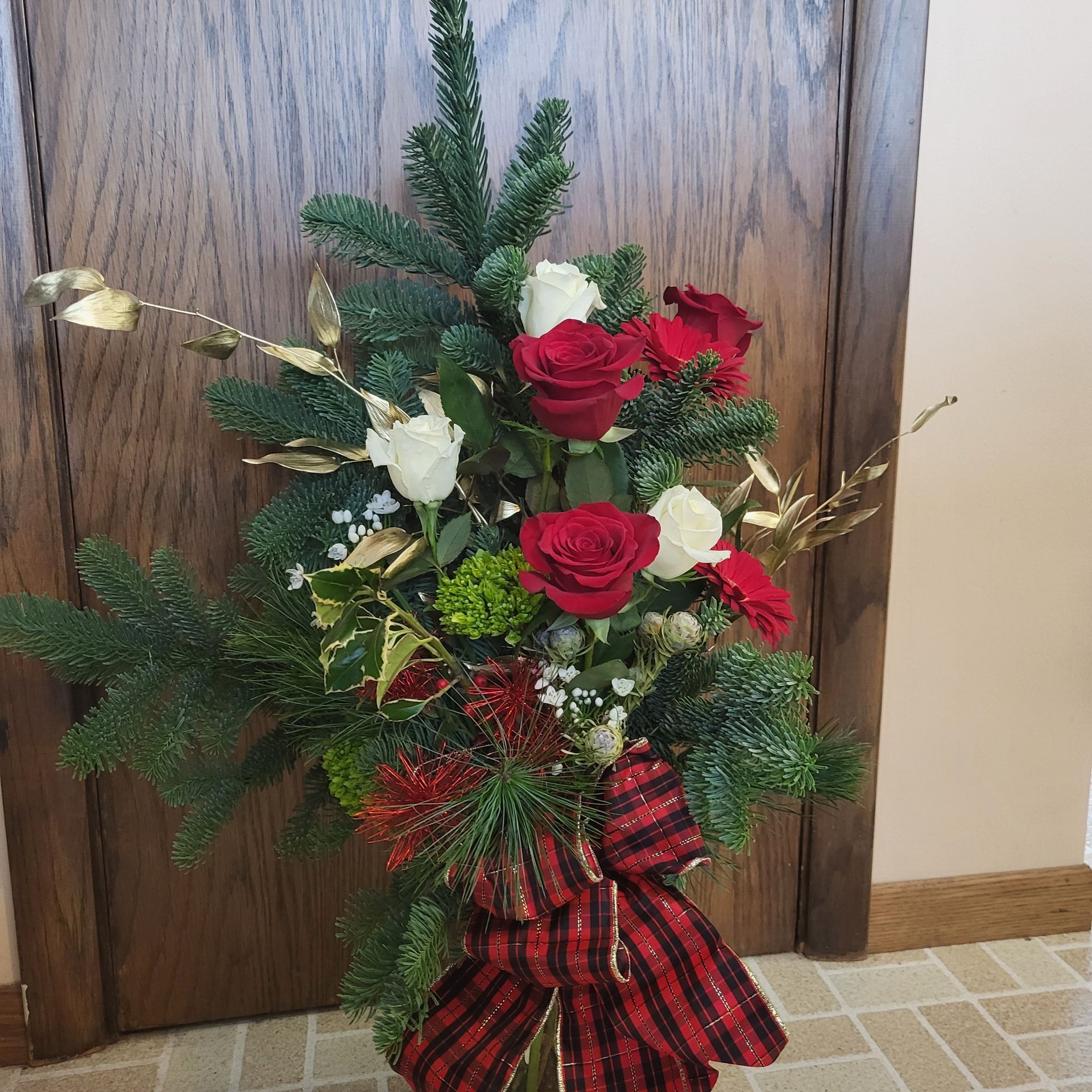 A bouquet of flowers with red roses and white flowers.