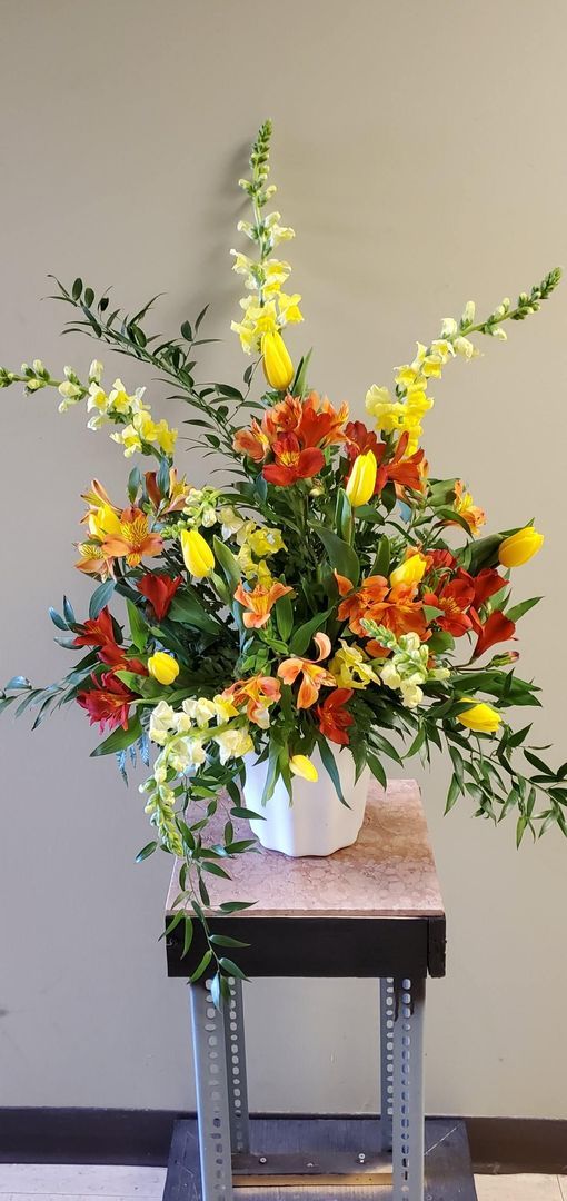 A vase filled with flowers is sitting on a table.