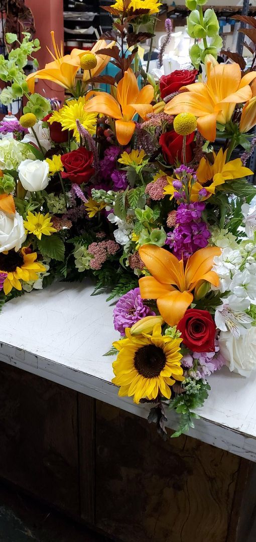 A bunch of flowers are sitting on top of a table.