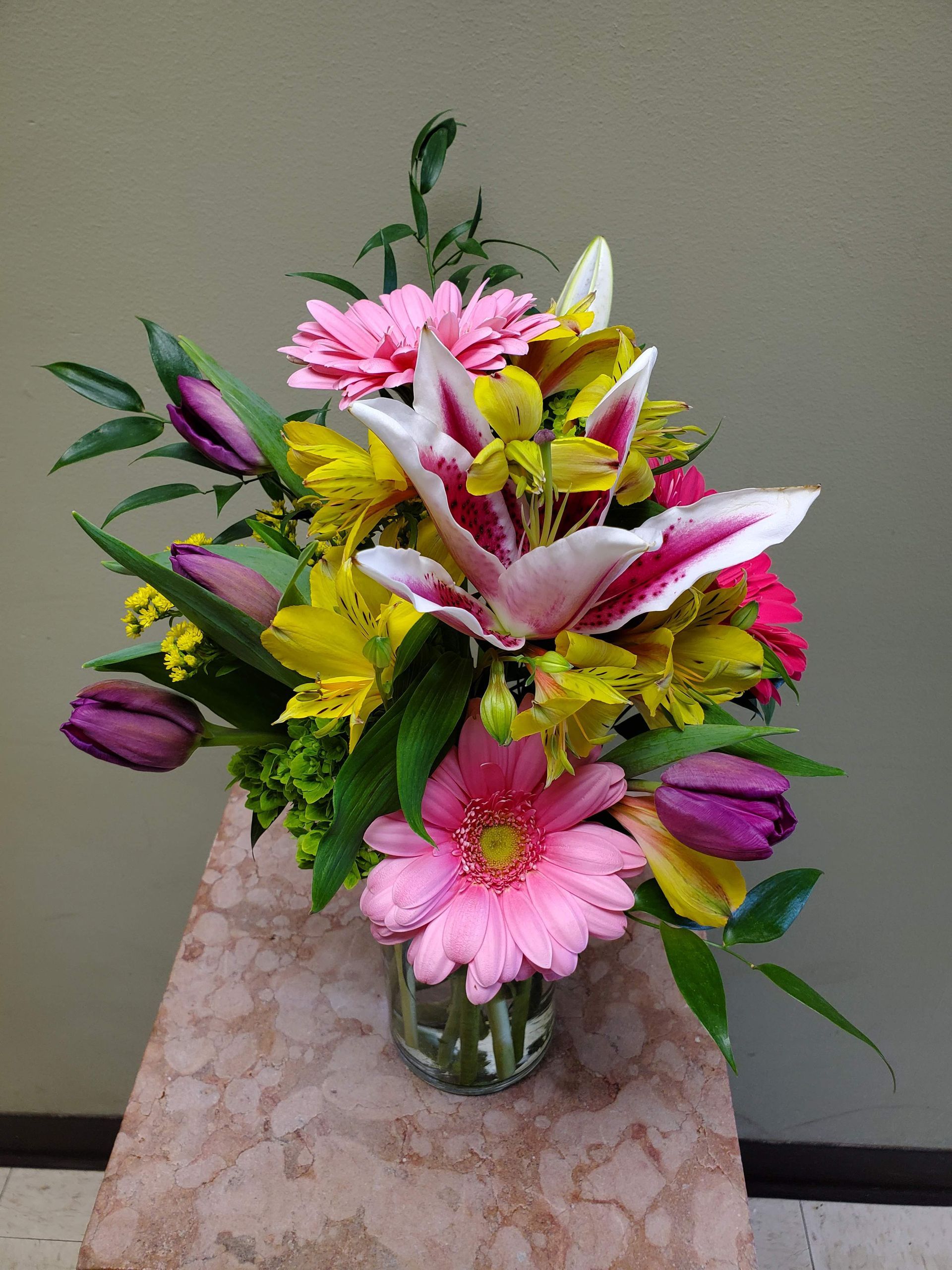 A vase filled with flowers is sitting on a table.