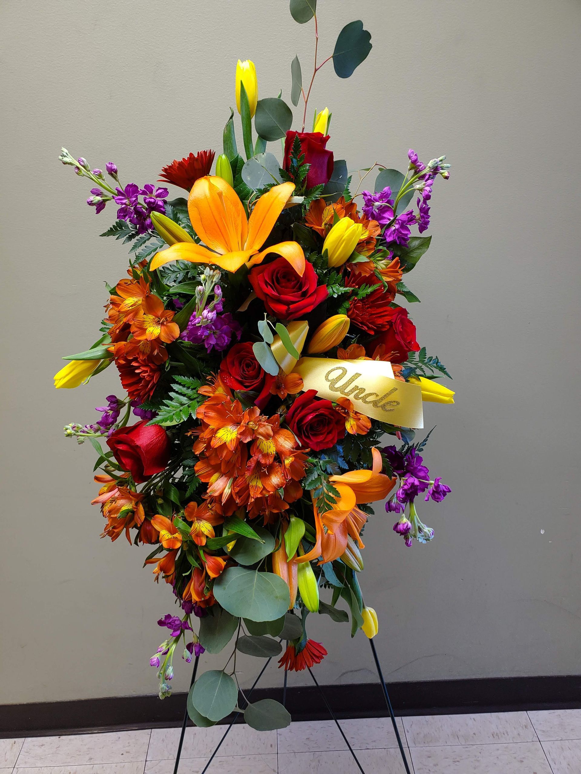 A display of flowers with a ribbon.