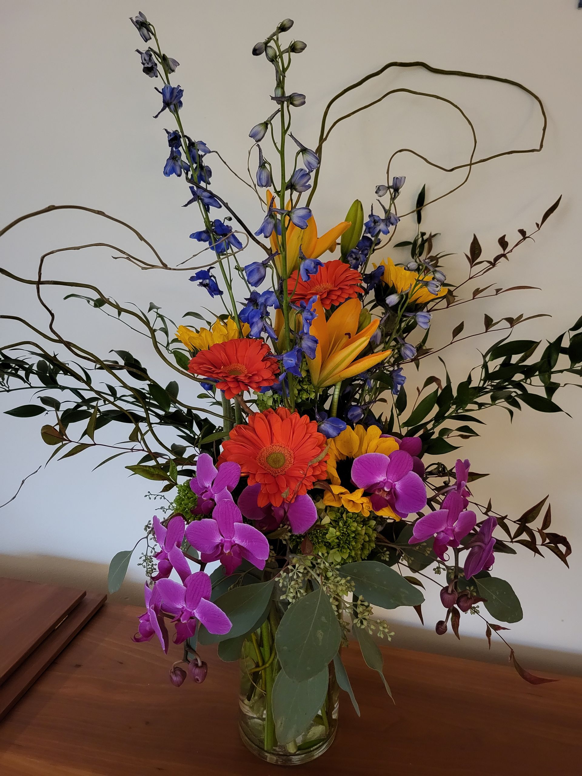 A vase filled with colorful flowers sits on a table