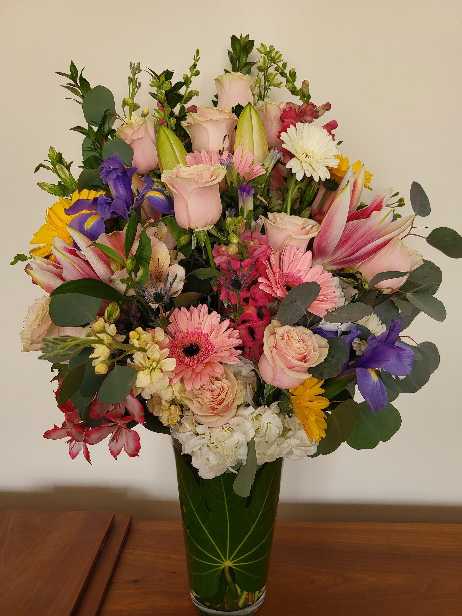 A vase filled with flowers is sitting on a table.