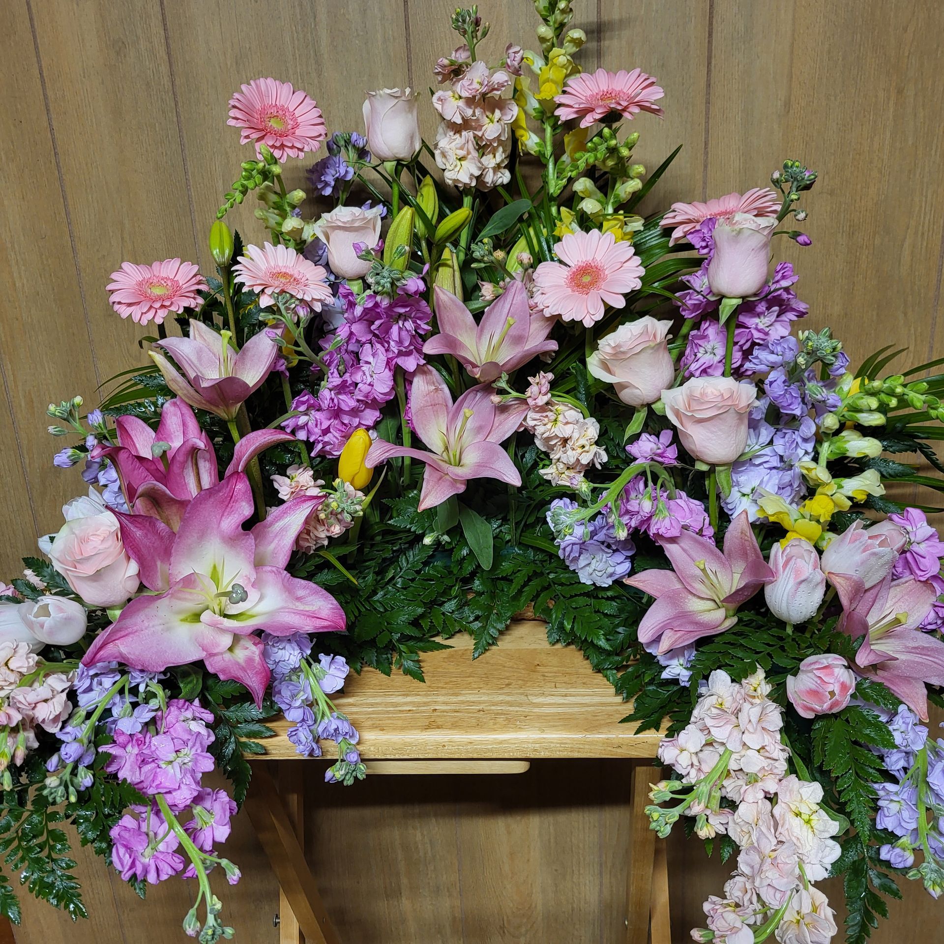 There are many different types of flowers in this arrangement.