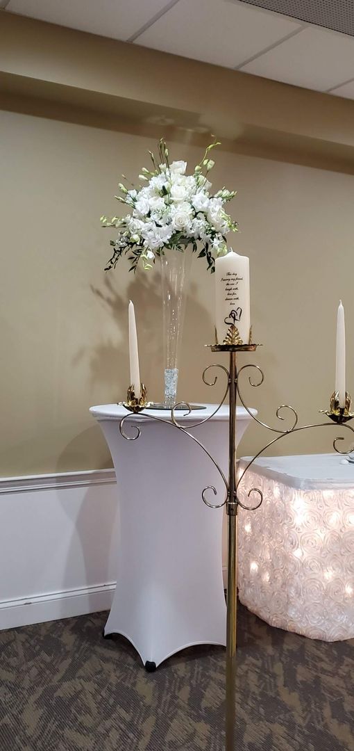 A bouquet of flowers is sitting on a wooden stool.
