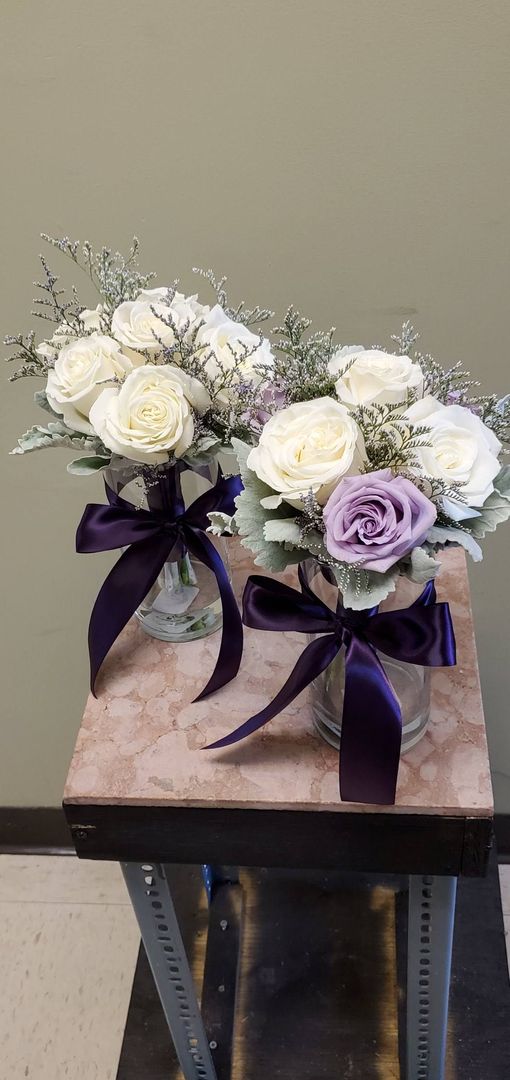 A bouquet of flowers is sitting on a wooden stool.