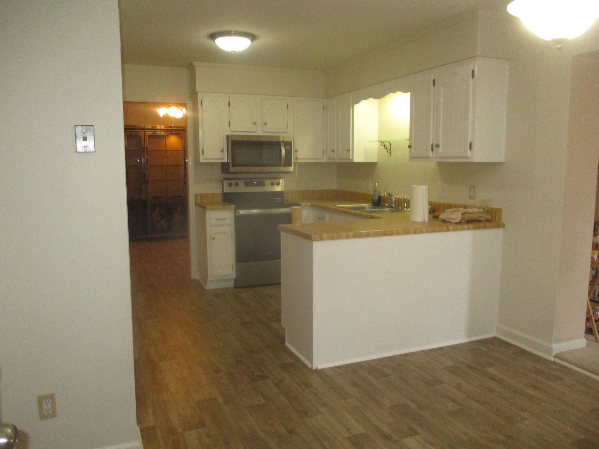 A kitchen with white cabinets and stainless steel appliances