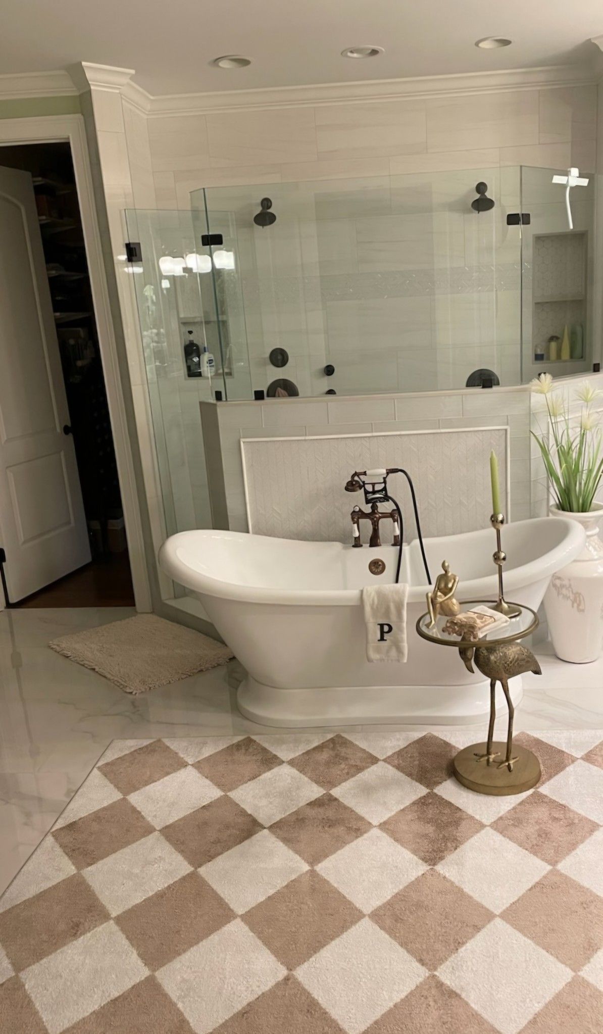 A bathroom with a bathtub and a checkered floor.
