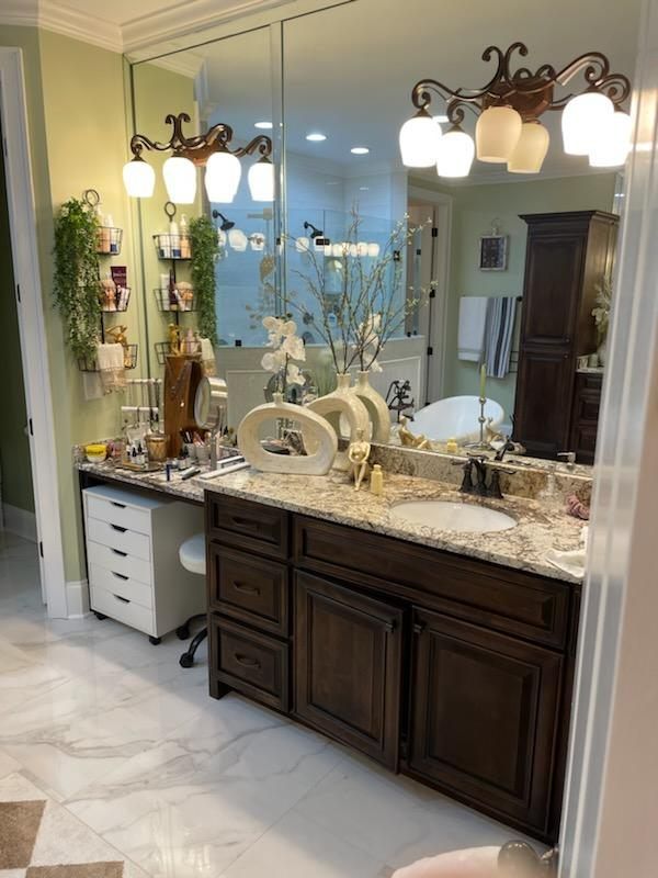 A bathroom with two sinks and a large mirror