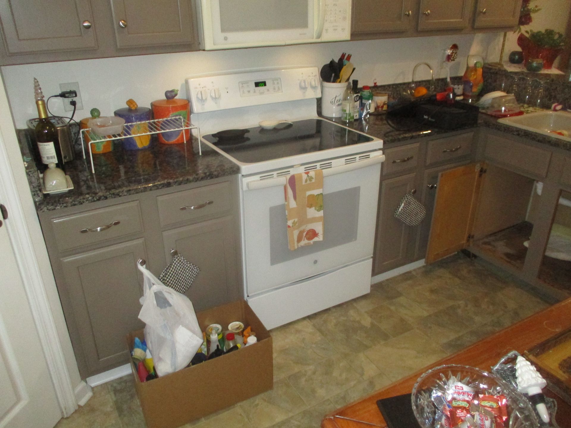 A kitchen with a stove top oven and a microwave