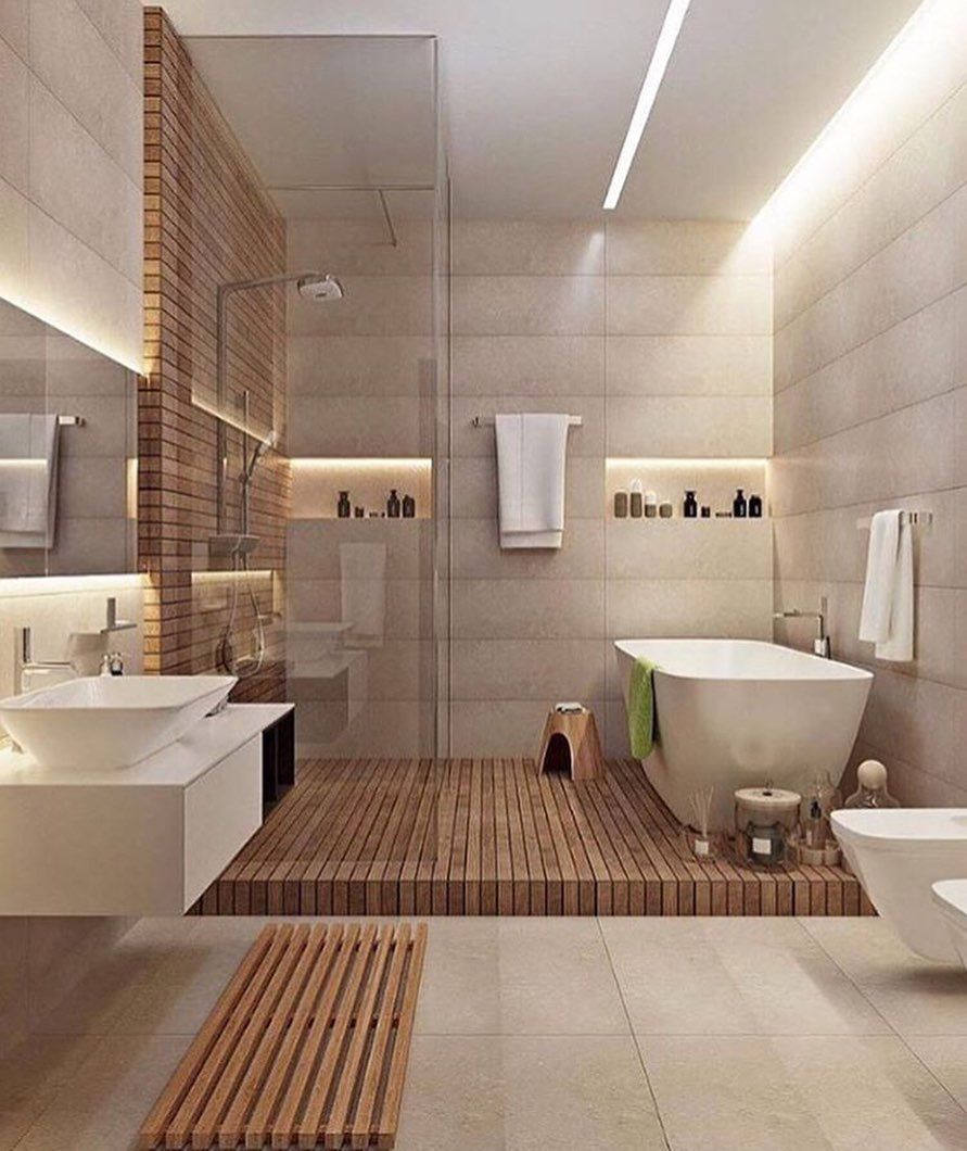 Modern bathroom with wooden accents, glass shower, freestanding tub, and neutral-colored tiles.