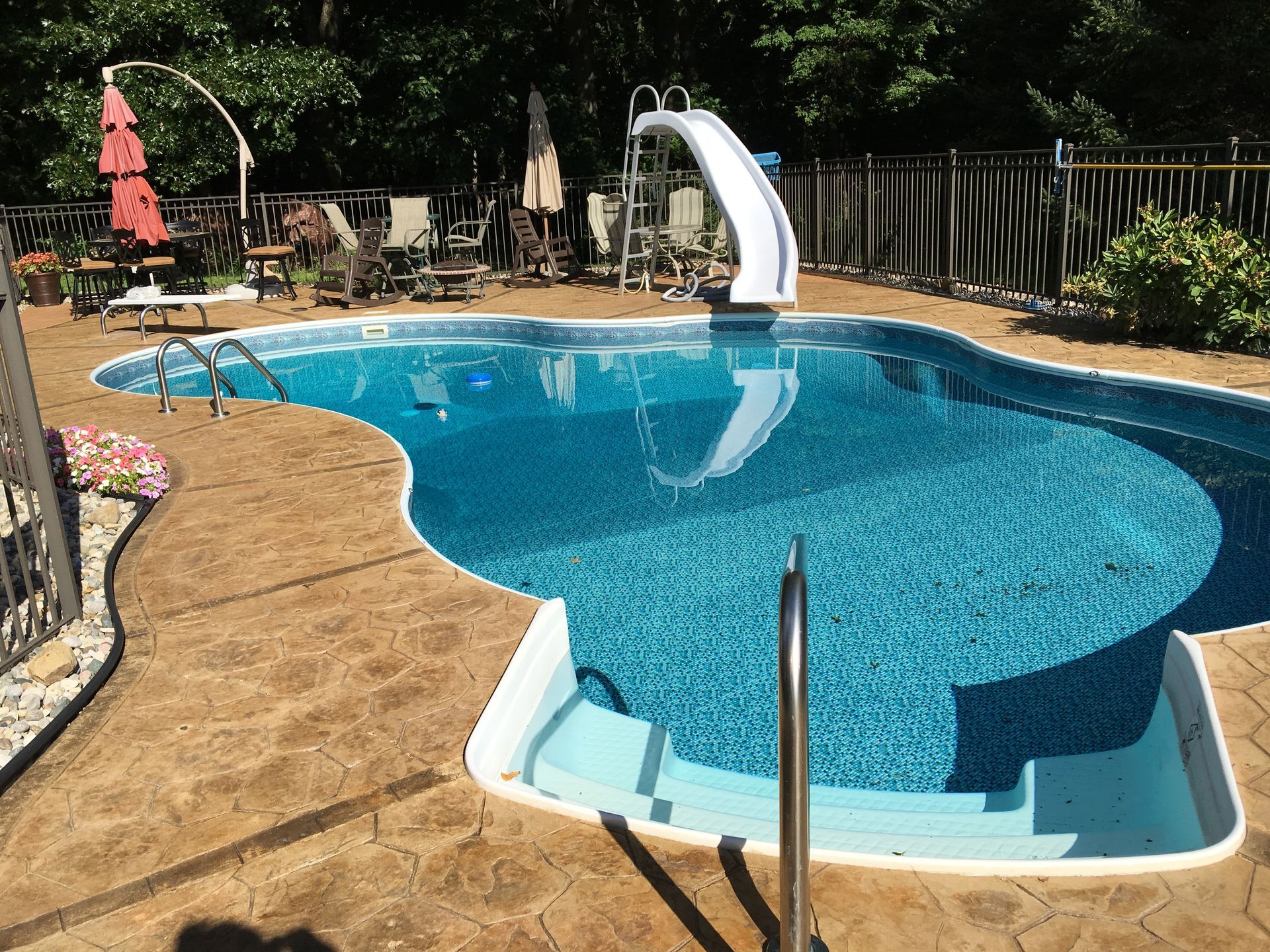 A large swimming pool with a slide attached to it