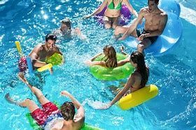 A group of people are floating on rafts in a swimming pool